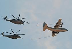 <p>
	A KC-130J Hercules is ready to refuel two CH-53E Super Stallion helicopters</p>